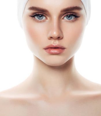 Indoor shot of young beautiful woman on light background. Natural beauty